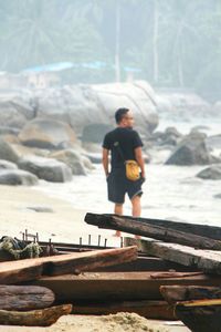 Full length of woman standing on shore