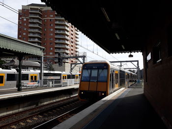 Train at railroad station in city