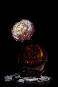 Close-up of statue against black background