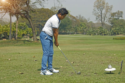 Full length of man standing on golf course