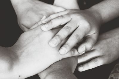 Close-up of cropped hand holding baby