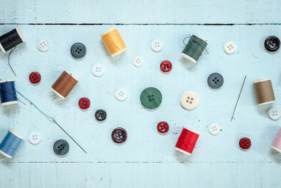 Directly above view of colorful sewing items on wooden table