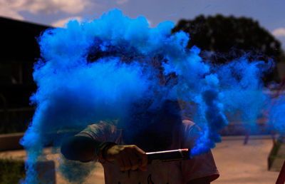 Girl with blue distress flare at night