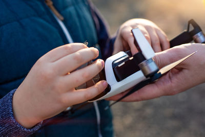 Midsection of man using mobile phone