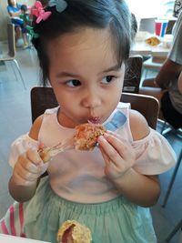 Portrait of cute girl eating food