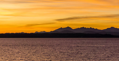 Scenic view of silhouette mountains against sky during sunset