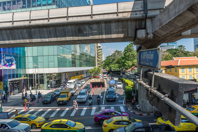 Traffic on road by buildings in city