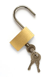 Close-up of padlocks hanging against white background