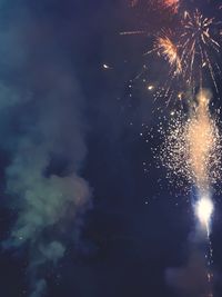 Low angle view of firework display at night