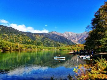 Scenic view of lake and mountains against sky