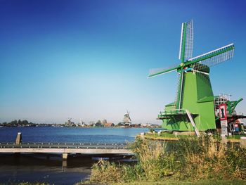 Traditional windmill against clear blue sky