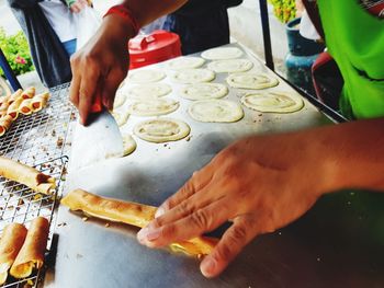 Close-up of person preparing food on table