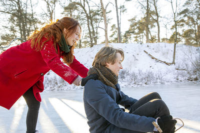 Side view of woman against snow during winter