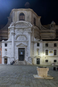 Facade of old building in city at night