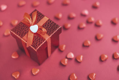 Red gift box on the background of hearts for valentine's day