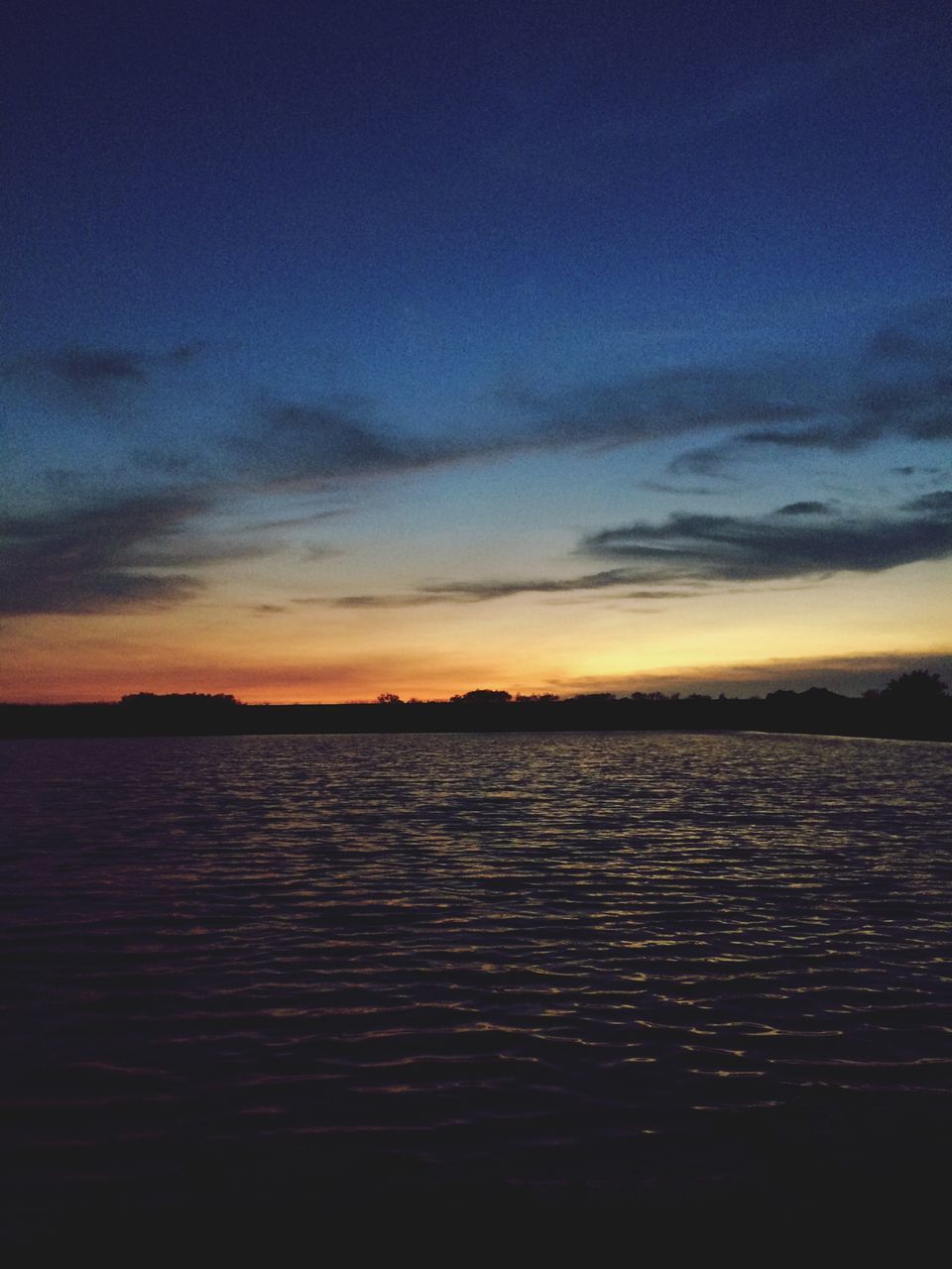 sunset, water, tranquil scene, scenics, tranquility, sky, beauty in nature, waterfront, sea, nature, cloud - sky, idyllic, silhouette, reflection, cloud, dusk, lake, rippled, calm, blue