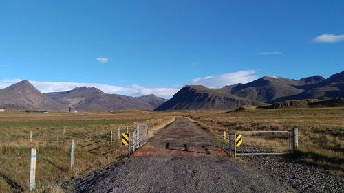 Scenic view of mountains against blue sky