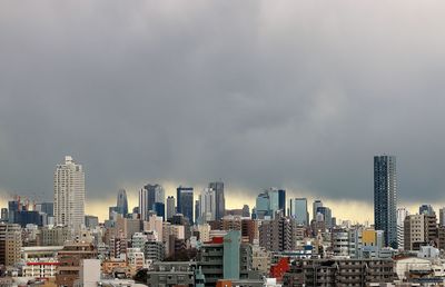 Cityscape against cloudy sky