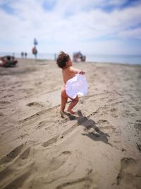 Rear view of boy on beach