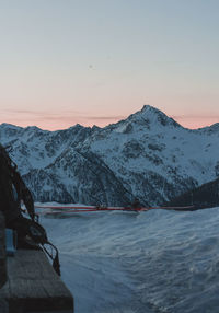 Scenic view of snowcapped mountains against sky during sunset