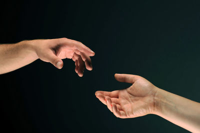 Midsection of people against black background