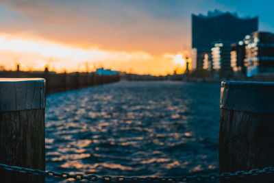 Close-up of wooden post against sky during sunset