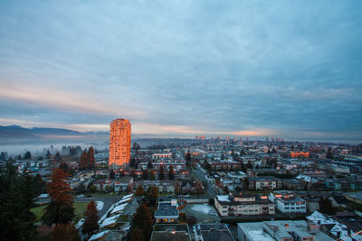 Buildings against cloudy sky