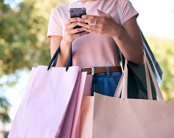 Midsection of woman using mobile phone