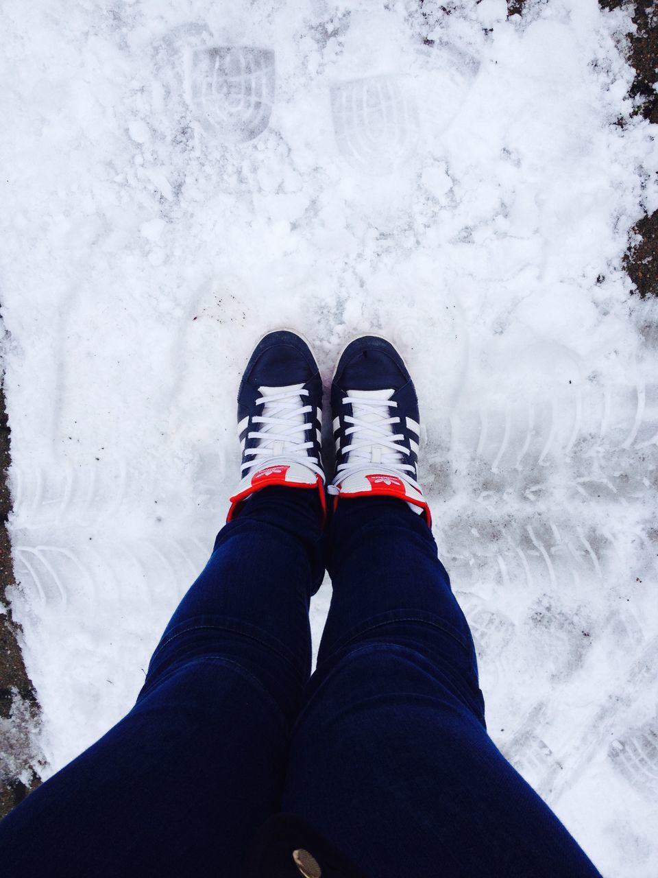 low section, shoe, person, snow, winter, personal perspective, cold temperature, season, lifestyles, standing, jeans, footwear, human foot, weather, high angle view, covering, leisure activity