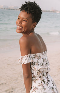 Mid adult woman standing at beach