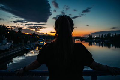 Rear view of woman looking at harbor