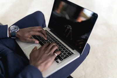 Young businessman working on laptop while sitting in hotel