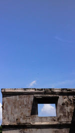 Low angle view of old building against clear blue sky