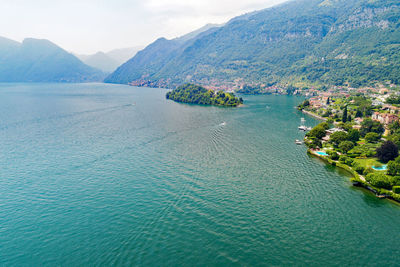 High angle view of sea and mountains against sky