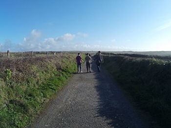 People walking on grassy field