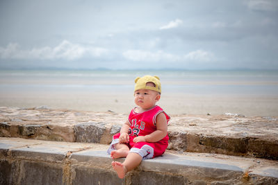 Boy sitting on beach