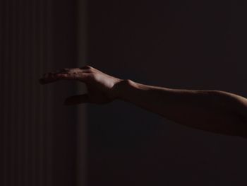 Close-up of hand against wall