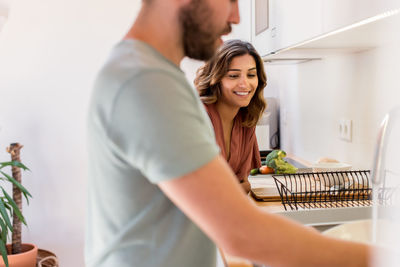 Couple standing in kitchen