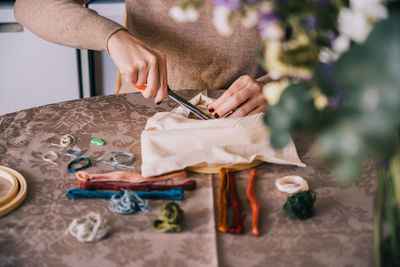 Midsection of woman working on table