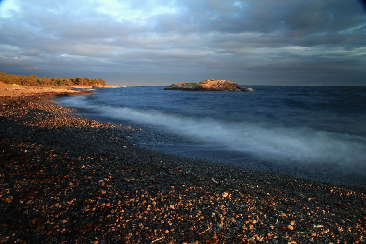 sea, water, sky, cloud - sky, horizon over water, beach, scenics, beauty in nature, shore, cloudy, tranquil scene, nature, tranquility, wave, weather, overcast, cloud, idyllic, rock - object, coastline, outdoors, dramatic sky, remote, no people, non-urban scene, travel destinations, ocean