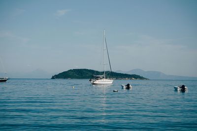 Sailboat sailing on sea against sky