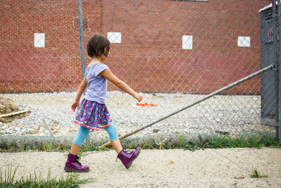 Full length of girl playing outdoors