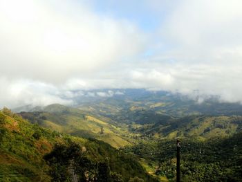 Scenic view of mountains against cloudy sky