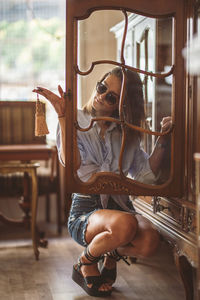 Portrait of young woman sitting on seat