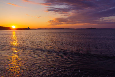 Scenic view of sea against romantic sky at sunset