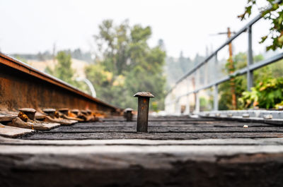 Close-up of rusty railroad track against clear sky