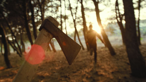 Chasing a victim with an axe in the woods, point of view shot