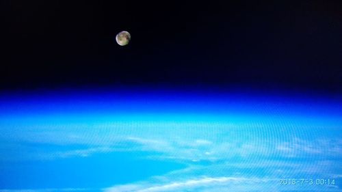 Scenic view of sea against moon at night