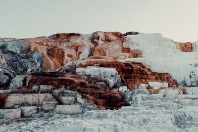 Rock formation against sky during winter