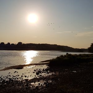 Scenic view of sunset over lake